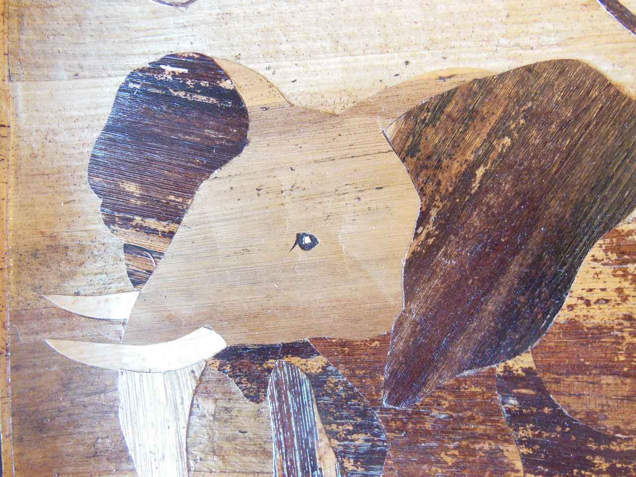 Tanzania- Intricately cut wood elephant on Fabric.  Framed.