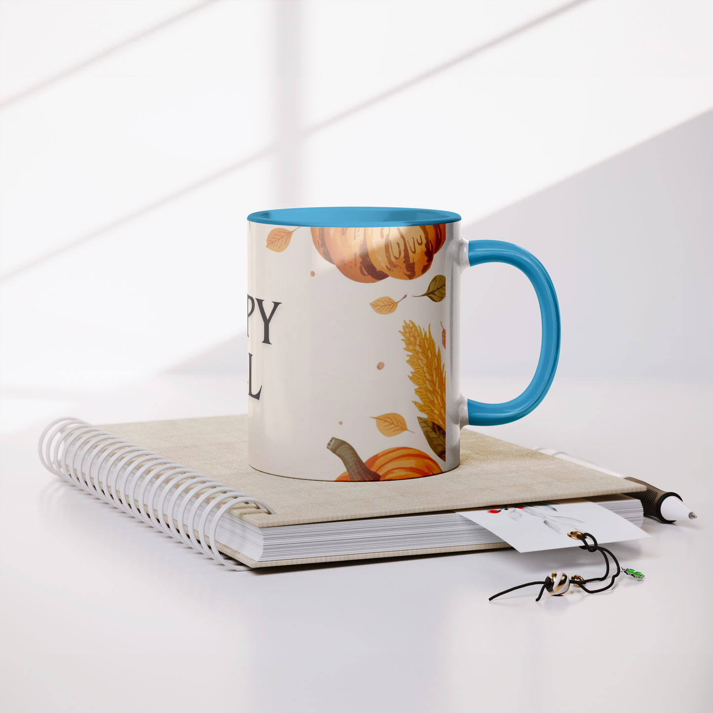 Happy_Fall_Mug_Blue_Handle_Lifestyle_Notebook_Mockup.png