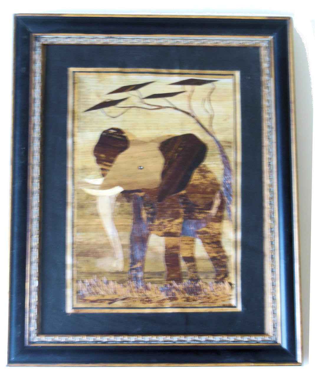 Tanzania- Intricately cut wood elephant on Fabric.  Framed.